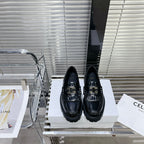 MARGARET CHUNKY LOAFER WITH FRINGES AND TRIOMPHE CHAIN IN POLISHED BULL BLACK
