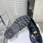 MARGARET CHUNKY LOAFER WITH FRINGES AND TRIOMPHE CHAIN IN POLISHED BULL GLOSSY BLACK