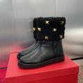 ANKLE STUDDED BOOTS IN BLACK CALFSKIN AND SHEARLING LINING